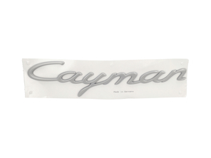 Cayman rear lid badge, primed. Porsche 987.1 Cayman - 98755998401